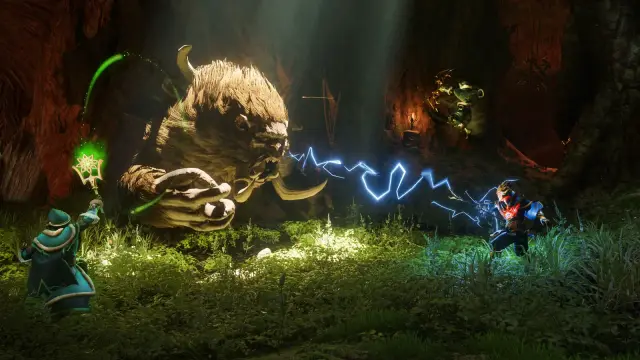 Three players fighting a large creature together inside a cave